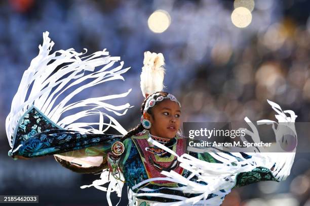 Young member of the Wind River Indian Reservation performs a tradition dance in a timeout during the first half at Folsom Field on November 16, 2024...