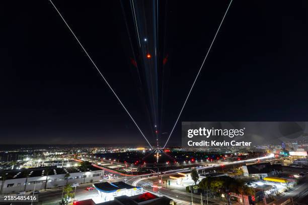 In a slow shutter speed photo, a Alaska Airlines Boeing 737-990 airplane arrives at San Diego International Airport from Seattle at night on November...