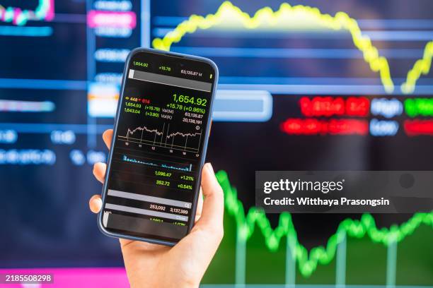 close-up of smartphone displaying stock market data and charts - computer files screen stock pictures, royalty-free photos & images