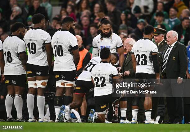 Dublin , Ireland - 23 November 2024; Fiji players, Peni Matawalu and Vilimoni Botitu genuflect in reverence to meeting President of Ireland Michael D...