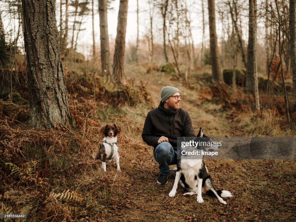 Man and his two dogs outdoors in rural nature in winter