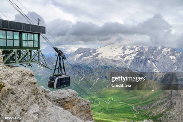 sass pordoi cable car from the passo pordoi up the mountain - overhead cable car stock pictures, royalty-free photos & images