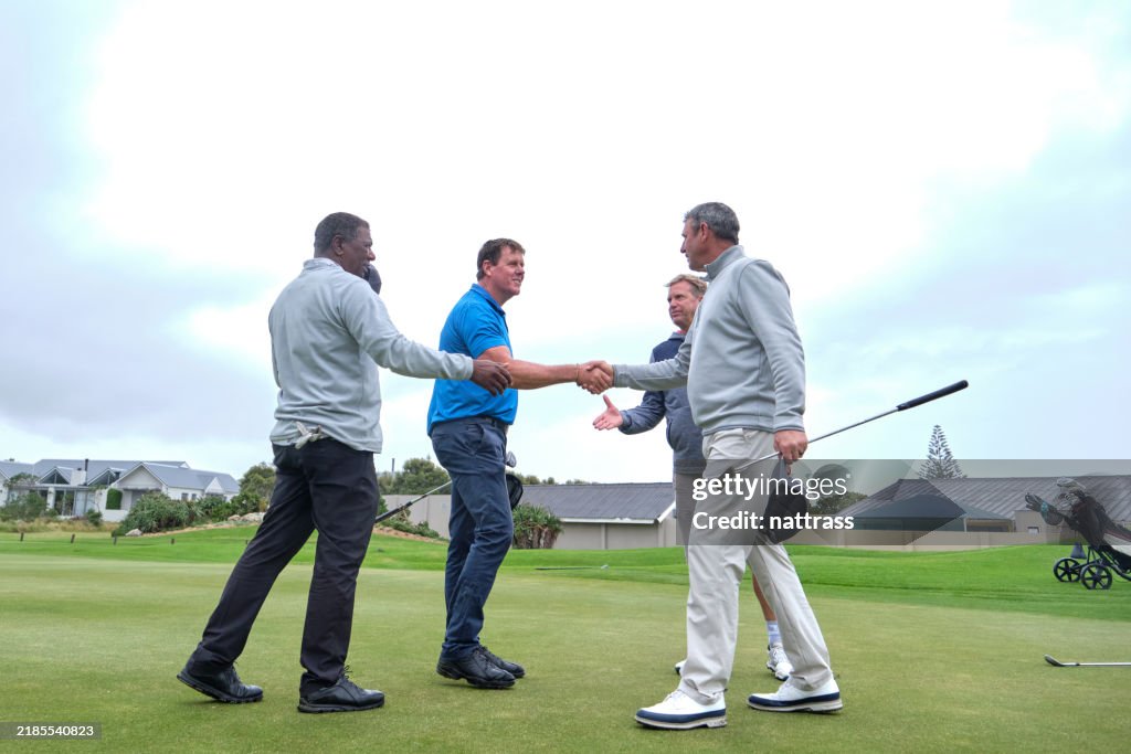 Golfers shake hands after a great game of golfers