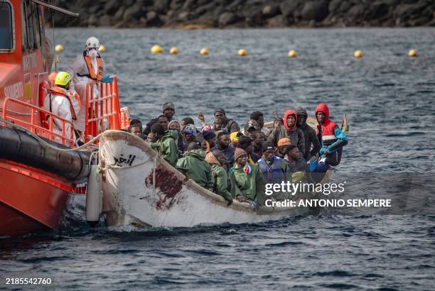 Cayuco' boat from Mauritania with 78 migrants onboard arrives after being rescued at sea by the Spanish Salvamento Maritimo Salvamar Acrux vessel, at...