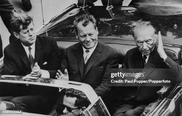 American Democratic Party politician John Fitzgerald Kennedy , President of the United States, seated on left with Mayor of Berlin Willy Brandt and,...