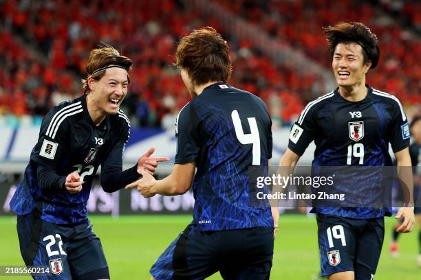 Kou Itakura of Japan celebrates with Ayumu Seko and Koki Ogawa after scoring the team's second goal against China in the first half during the FIFA...