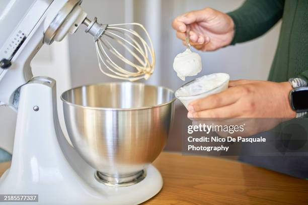 man adding yogurt to homemade cake batter - stand mixer stock pictures, royalty-free photos & images