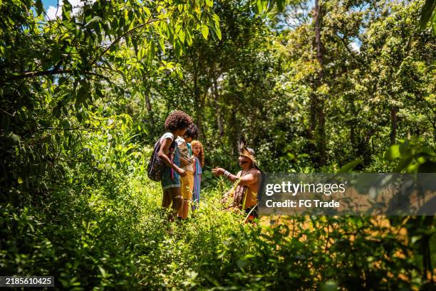 indigenous man showing how to use a trap to fish during a field trip to the indigenous tribe - amazon rainforest stock pictures, royalty-free photos & images