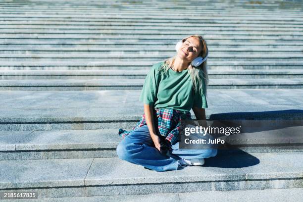 Mid Adult Woman Listening To Music High-Res Stock Photo