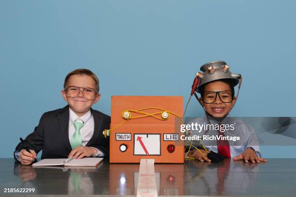 boys with homemade lie detector machine - true or false stock pictures, royalty-free photos & images