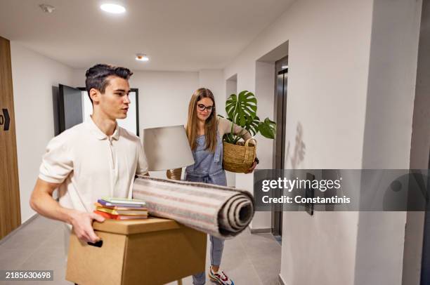 entering the elevator with boxes - entering stock pictures, royalty-free photos & images