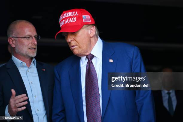 President-elect Donald Trump speaks to Brendan Carr, his intended pick for Chairman of the Federal Communications Commission, as he attends a viewing...