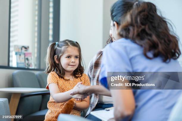 pediatrician greets young patient - triage stock pictures, royalty-free photos & images