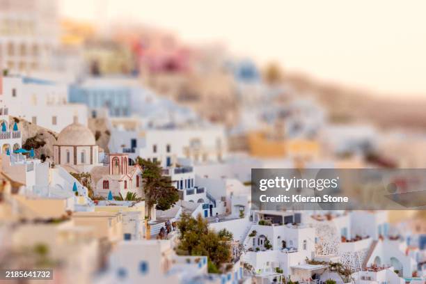 santorini buildings in oia greece with mules and church - tilt shift stock pictures, royalty-free photos & images