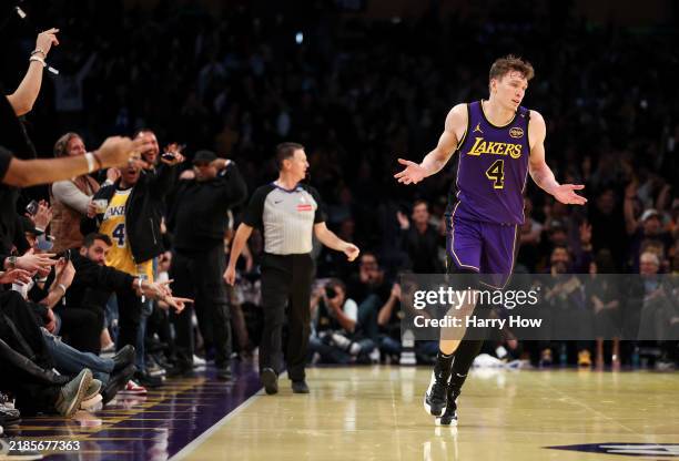 Dalton Knecht of the Los Angeles Lakers reacts after scoring his fourth consecutive 3-point basket against the Utah Jazz during the third quarter of...