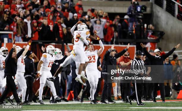 Darien Porter of the Iowa State Cyclones jumps into the arms of teammate Myles Purchase after beating the Utah Utes during the second half of their...