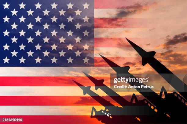 missiles with american flag in the background - radioaktive verseuchung stock-fotos und bilder