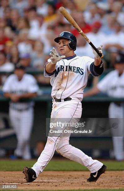 Bret Boone of the Seattle Mariners hits a three-run homer against the Tampa Bay Devil Rays during the game at Safeco Field on July 11, 2003 in...