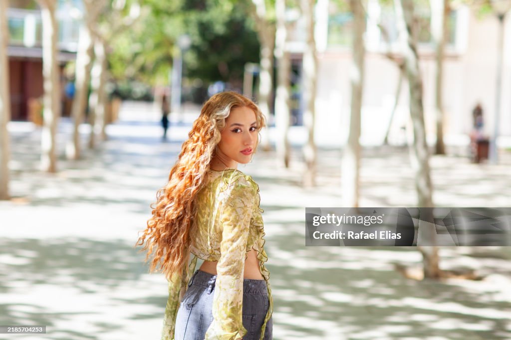 Pretty young woman turning back in the street