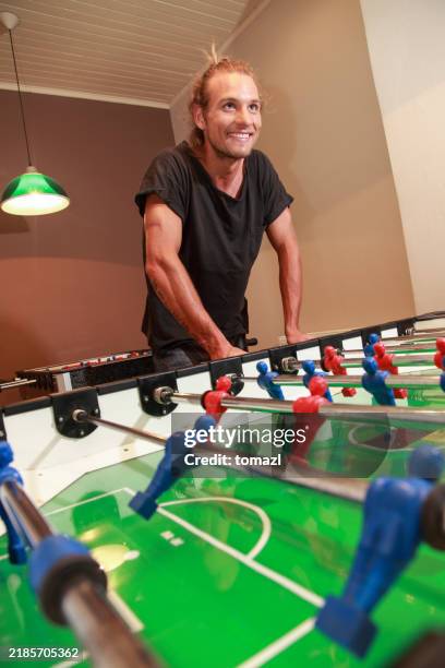 playing foosball at work - table football stock pictures, royalty-free photos & images