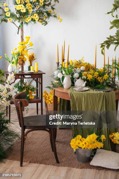 interior with floral decor. table setting in spring style with mimosa and tulips. spring. easter. mothers day. women's day. - spring kitchen stock pictures, royalty-free photos & images