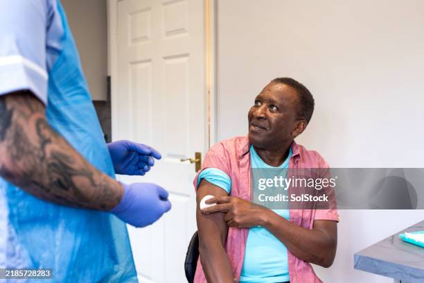 smiling senior with community carer - aged care vaccine stock pictures, royalty-free photos & images