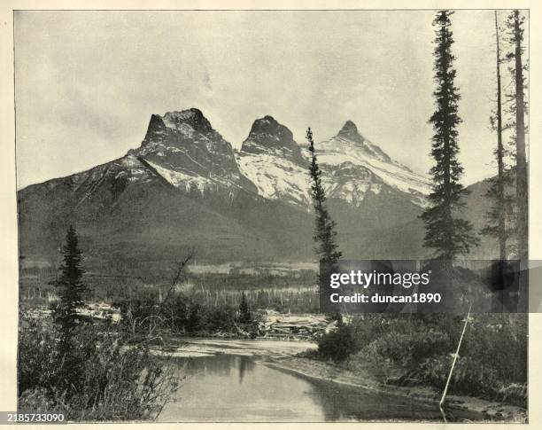 the three sisters are a trio of peaks near canmore, alberta, canada, 19th century, vintage photograph - canmore canada stock illustrations