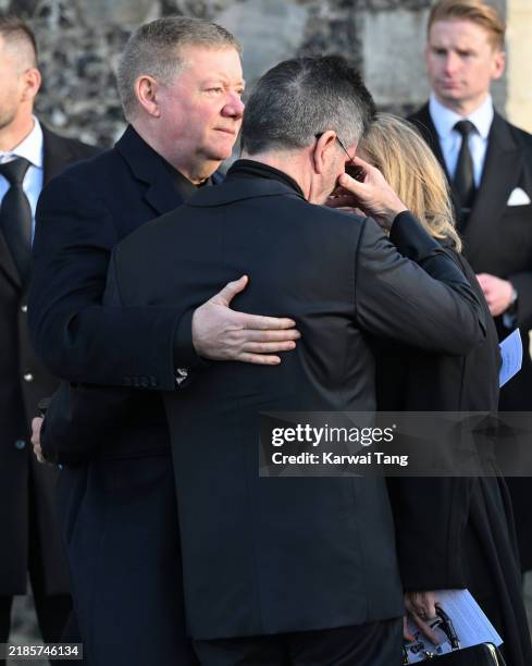 Simon Cowell is comforted by Geoff Payne as they depart the funeral for singer Liam Payne, former member of One Direction, on November 20, 2024 in...