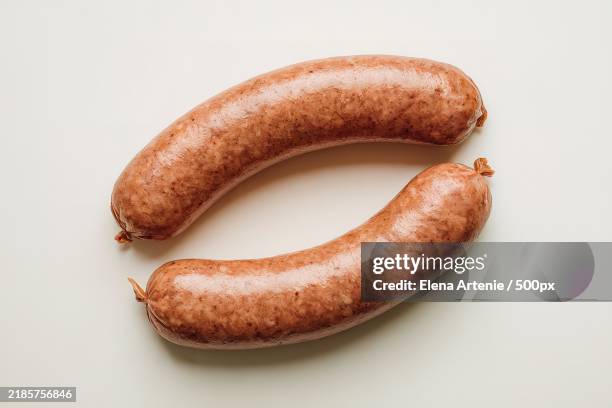 two sausages on a white background - pork sausage stock pictures, royalty-free photos & images