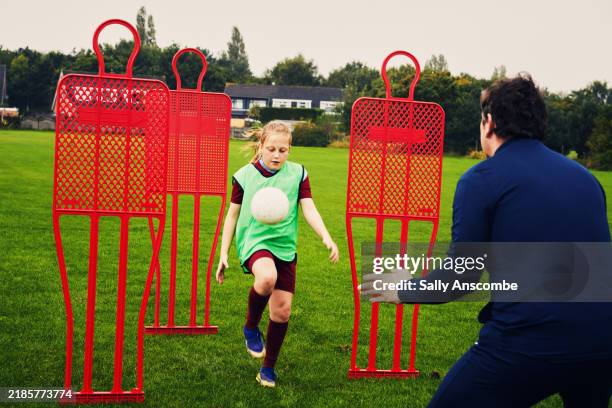 young girl working on her football training outdoors - practising stock pictures, royalty-free photos & images