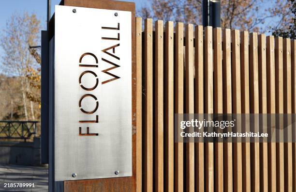 flood wall sign on bow river pathway, sw calgary, canada - calgary flood stock pictures, royalty-free photos & images