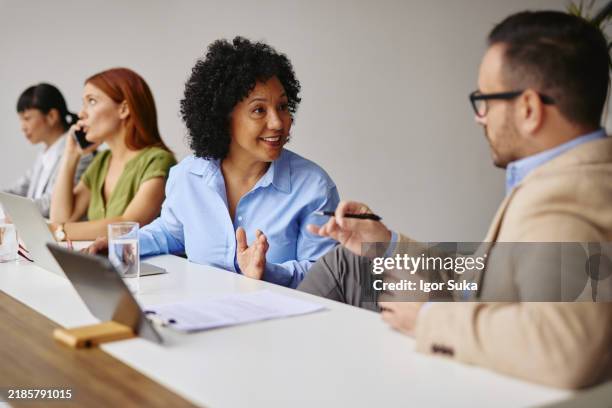 friendly colleagues collaborating in a modern office setting - simplification stock pictures, royalty-free photos & images