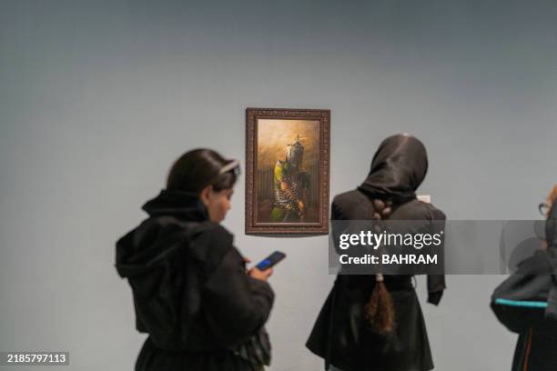Visitors explore the "Eye to Eye" exhibition at the Tehran Museum of Contemporary Art, in Tehran, Iran, November 23, 2024. The exhibition showcases...