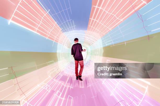 young man standing in abstract vr corridor - maths fun stock pictures, royalty-free photos & images