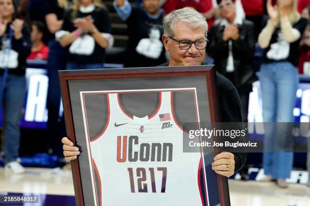 Connecticut Huskies head coach Geno Auriemma is presented with a jersey after becoming the NCAA all-time basketball wins leader at the Harry A....