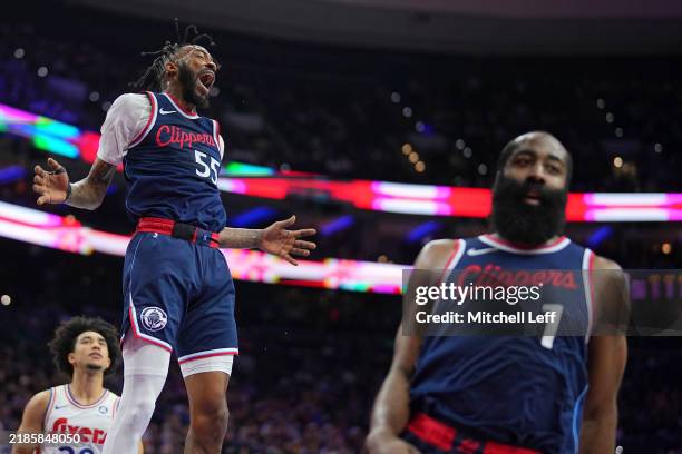 Derrick Jones Jr. #55 of the LA Clippers reacts after dunking the ball on an assist from James Harden against the Philadelphia 76ers in the first...