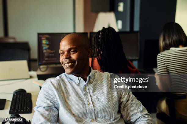 smiling computer programmer coding artificial intelligence in office - software programmer stock pictures, royalty-free photos & images