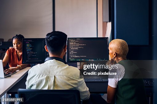 Focused asian computer programmer working on code in office Focused asian computer programmer working on code in office