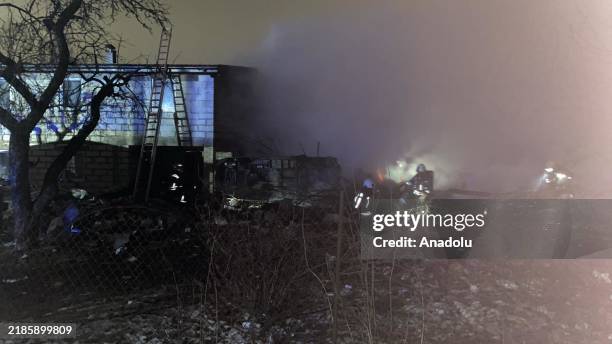 Firefighters work at the crash site of a cargo plane near the Vilnius International Airport in Vilnius on November 25, 2024. A cargo plane flying...