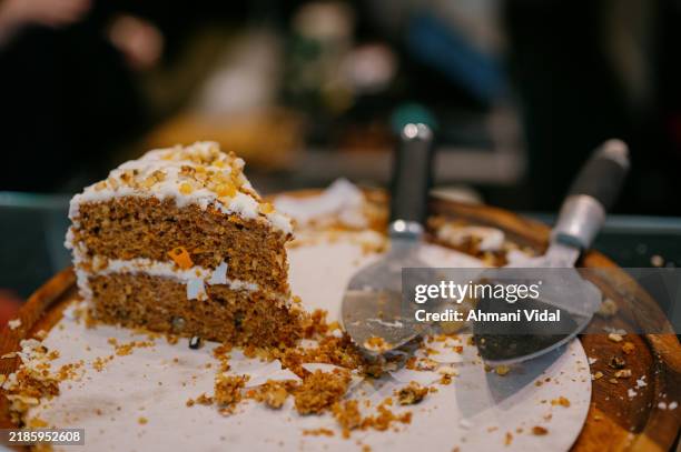 a slice of carrot cake on a serving dish - carrot cake stock pictures, royalty-free photos & images