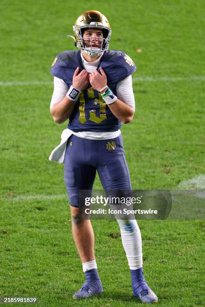 Riley Leonard of the Notre Dame Fighting Irish looks up st the scoreboard during the third quarter of the game against the Army Black Knights on...
