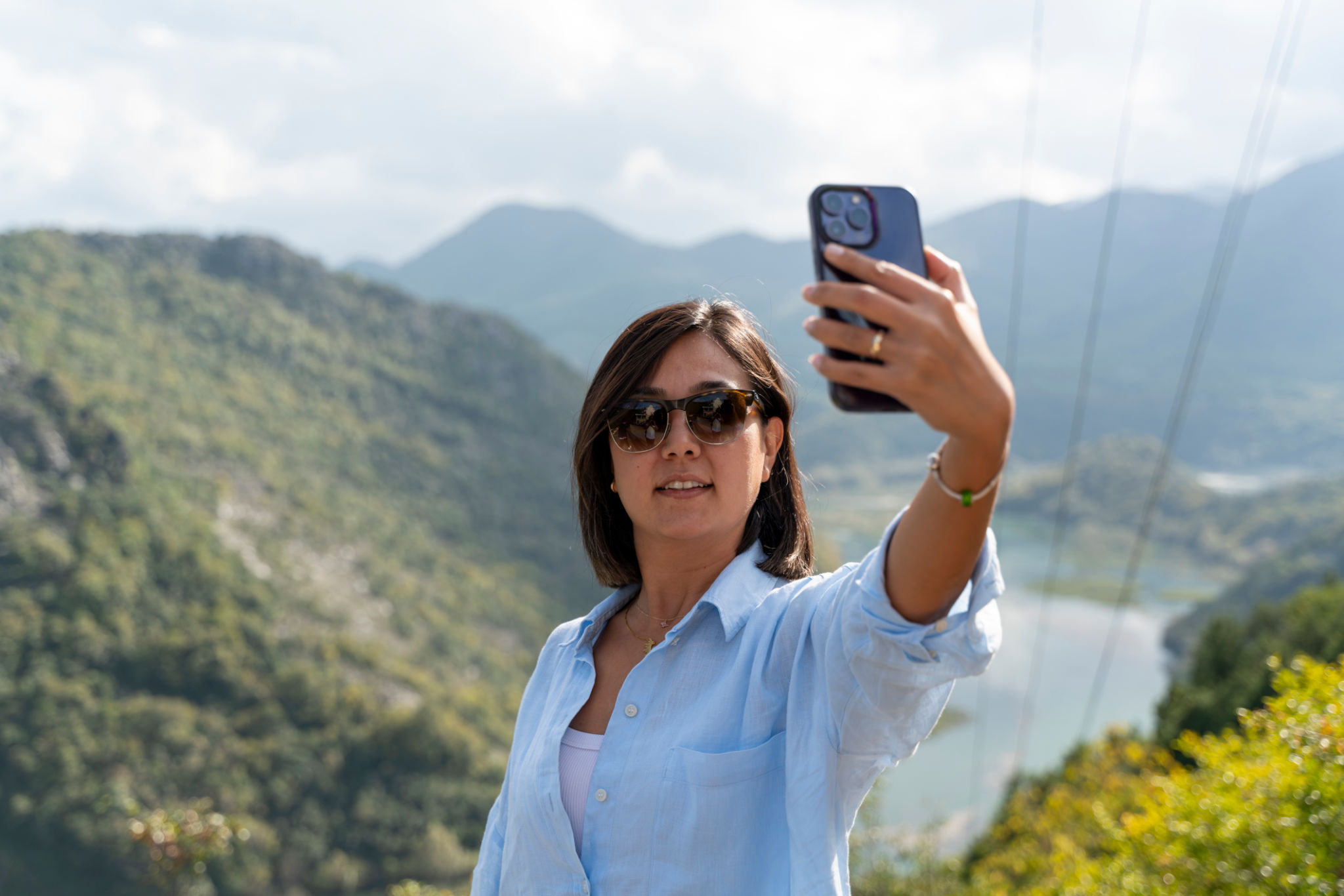 woman taking selfie photo in beautiful landscape. woman taking selfie photo in beautiful landscape.