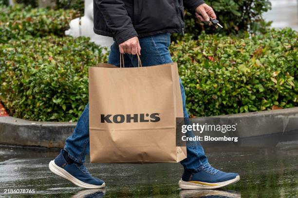 Shopper carries a Kohl's bag outside the company's store in Pleasant Hill, California, US, on Monday, Nov. 25, 2024. Kohl's Corp. Is expected to...