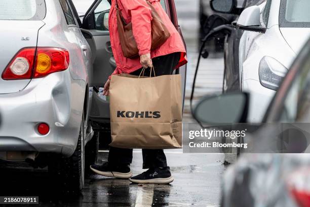 Shopper carries a Kohl's bag outside the company's store in Pleasant Hill, California, US, on Monday, Nov. 25, 2024. Kohl's Corp. Is expected to...