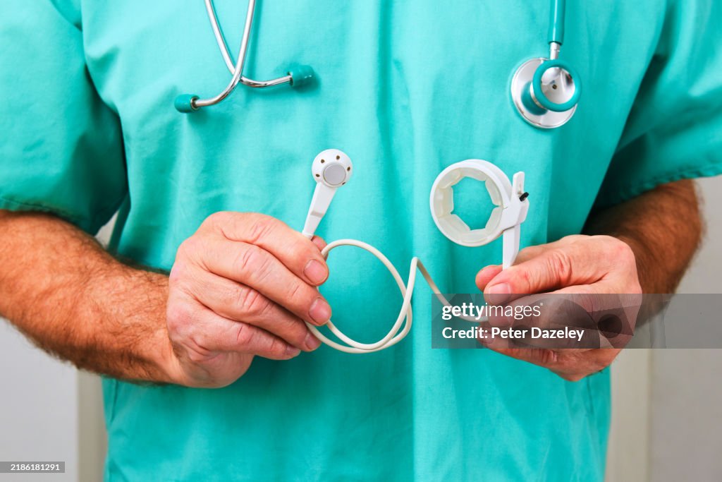 Surgeon holding a gastric band -