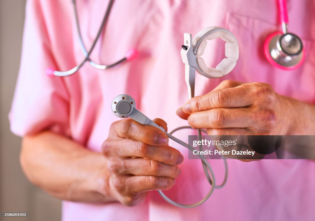 Surgeon holding a gastric band -