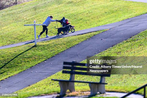 Brittany and Evelyn Coogan walk King towards the eighth green at Capital Hills Golf Course on Wednesday, Nov. 20 in Albany, NY. The course closed for...