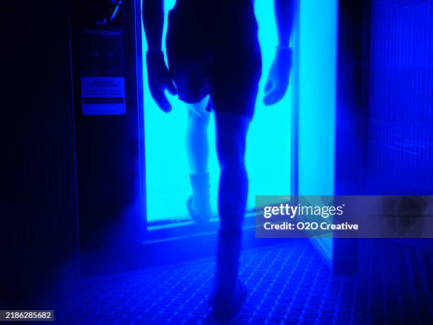 man entering a cryotherapy cold therapy chamber - cryotherapy chamber stock pictures, royalty-free photos & images