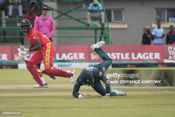 Pakistan's Mohammad Hasnain drops the ball as Zimbabwe's Brandon Mavuta makes a run during the second one day international cricket match between...