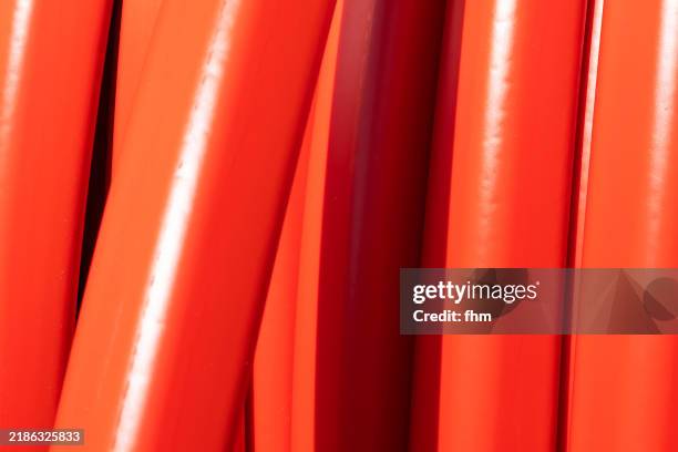 rolled up red cabel on a cable drum - cable spool stock pictures, royalty-free photos & images